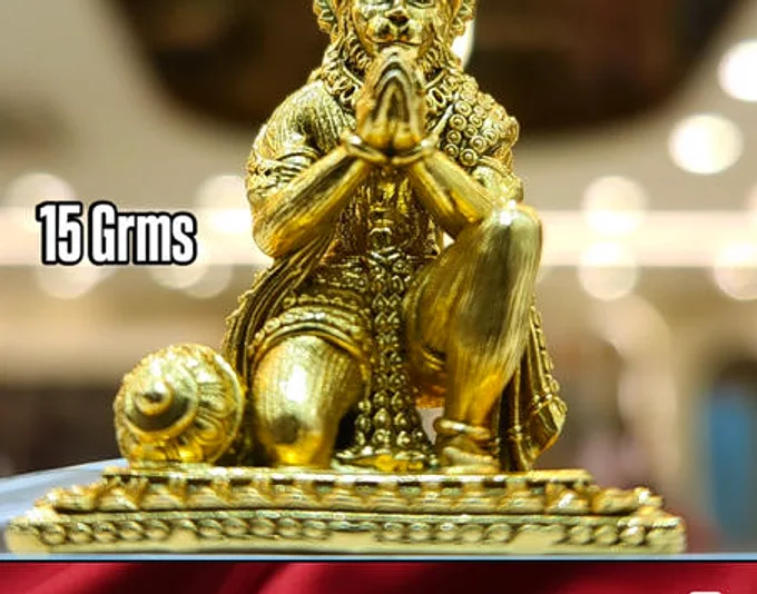 A golden seated Hanuman idol, captioned 15 grams on their reel