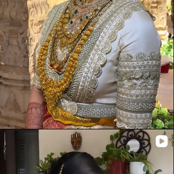 A bride in white and silver temple wear, hair dressed with flowers, seen from the side